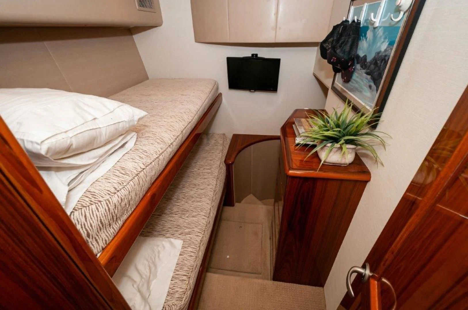 a bed with a plant on the side aboard POUR INTENTIONS Yacht for Sale