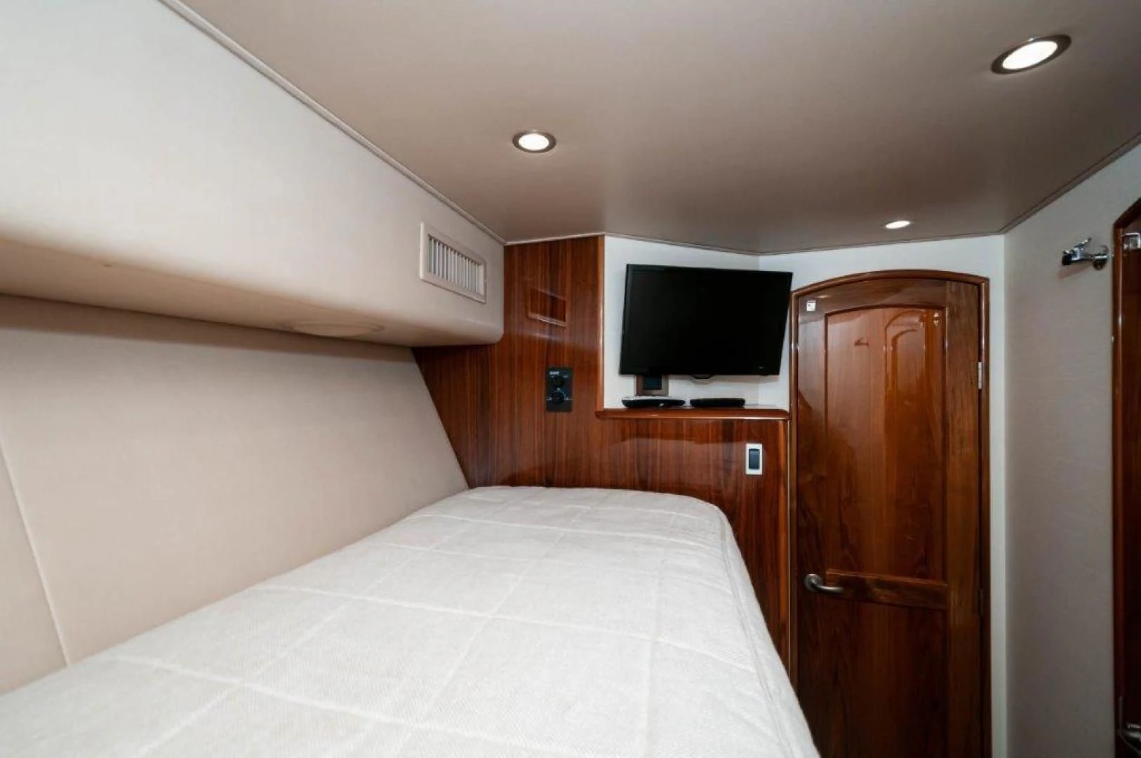 a bedroom with a bed and a television aboard POUR INTENTIONS Yacht for Sale