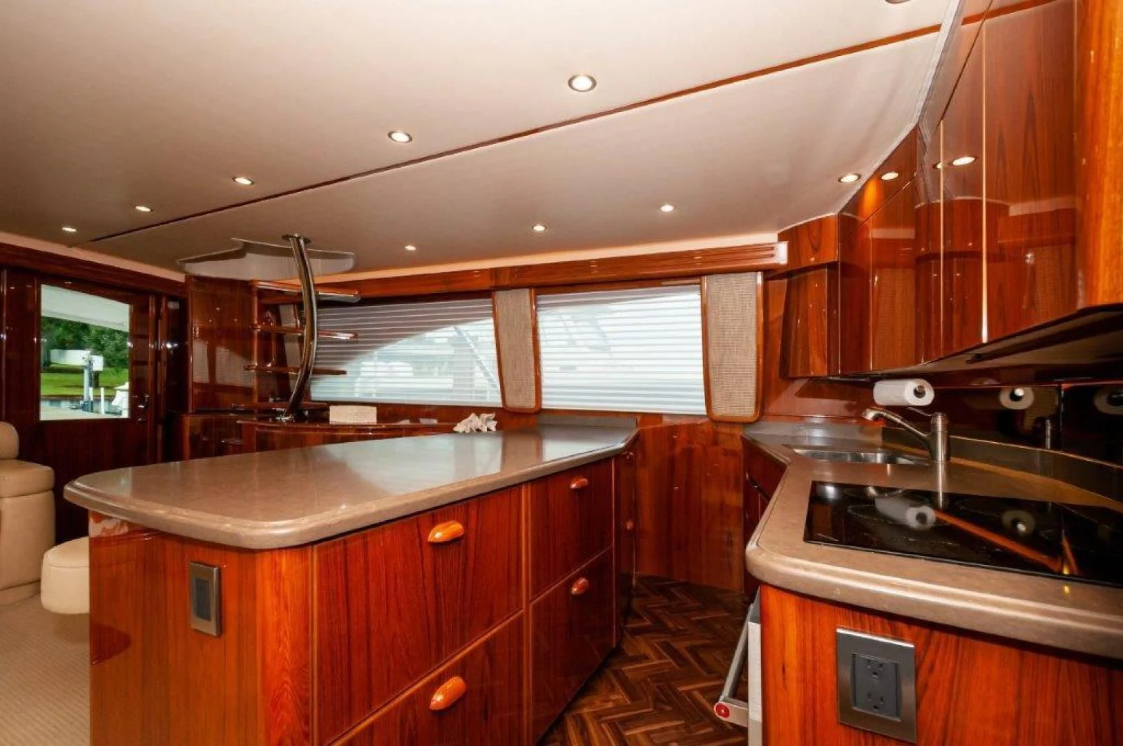 a kitchen with wooden cabinets aboard POUR INTENTIONS Yacht for Sale