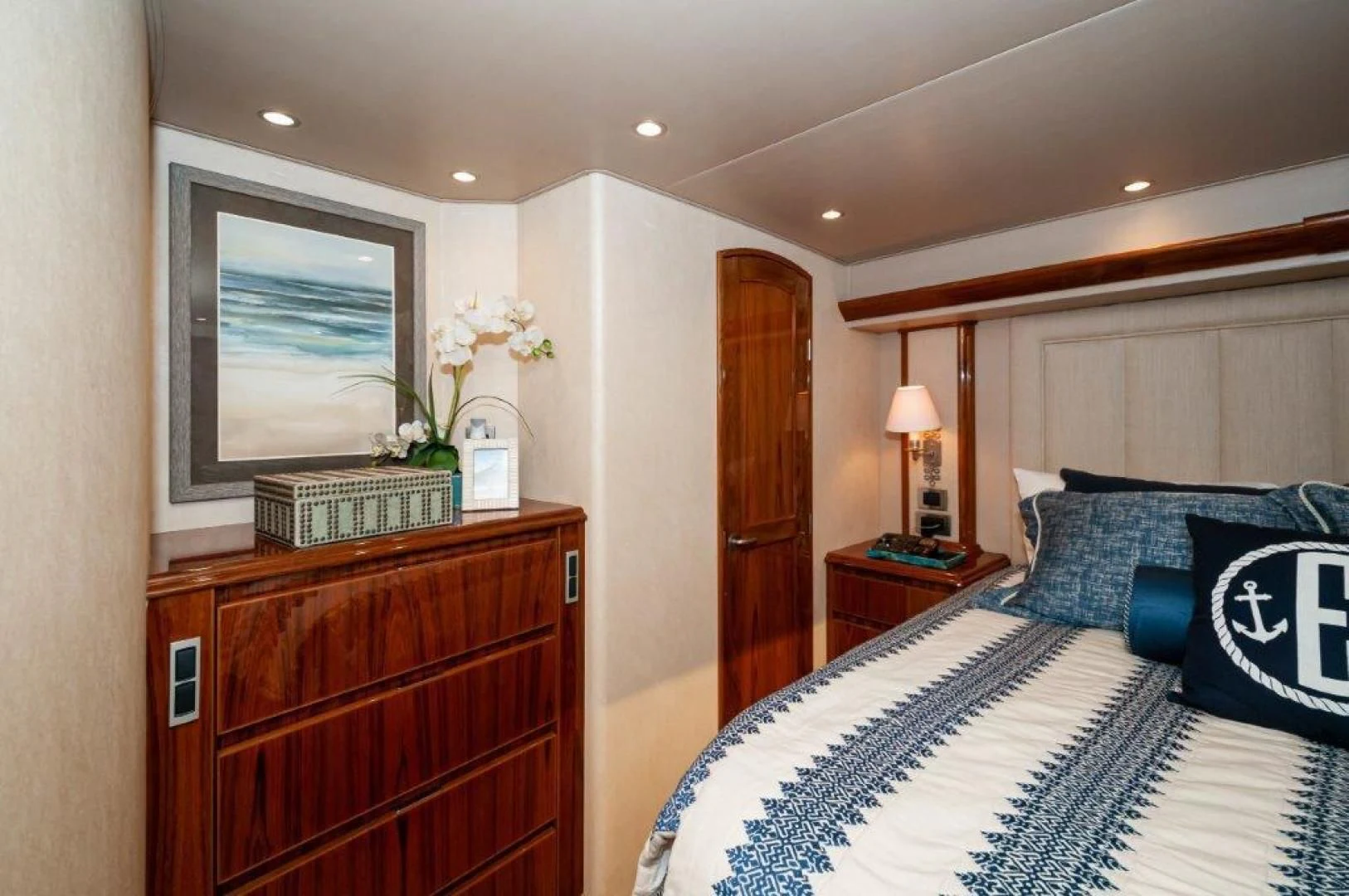 a bedroom with a bed and a dresser aboard POUR INTENTIONS Yacht for Sale