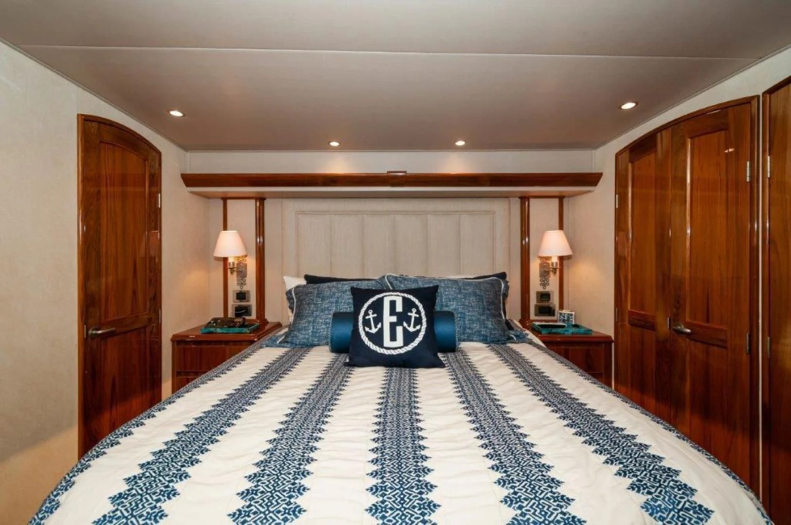 a bed with blue and white sheets aboard POUR INTENTIONS Yacht for Sale