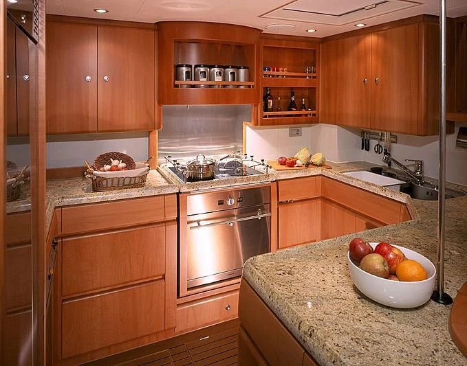 a kitchen with wooden cabinets aboard STALLA DE MUR Yacht for Sale