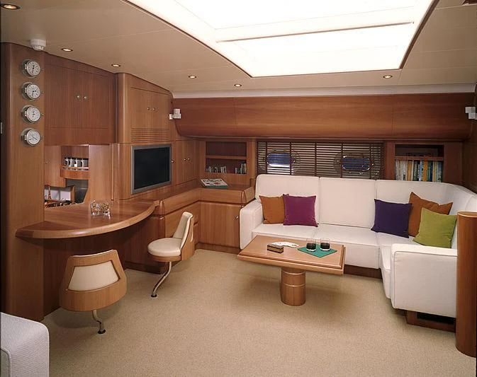 a living room with a couch and a table aboard STALLA DE MUR Yacht for Sale