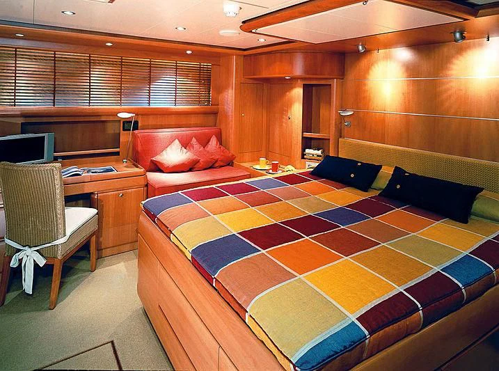 a bedroom with a bed and desk aboard STALLA DE MUR Yacht for Sale