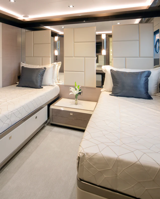 a room with two beds aboard MAVERICK Yacht for Sale
