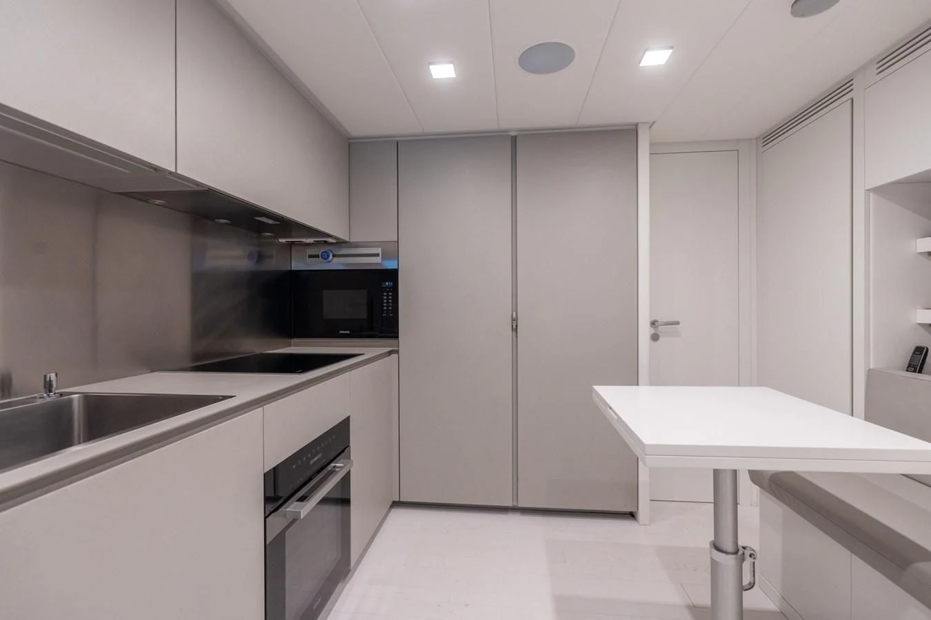 a kitchen with white cabinets aboard VINTAGE Yacht for Sale