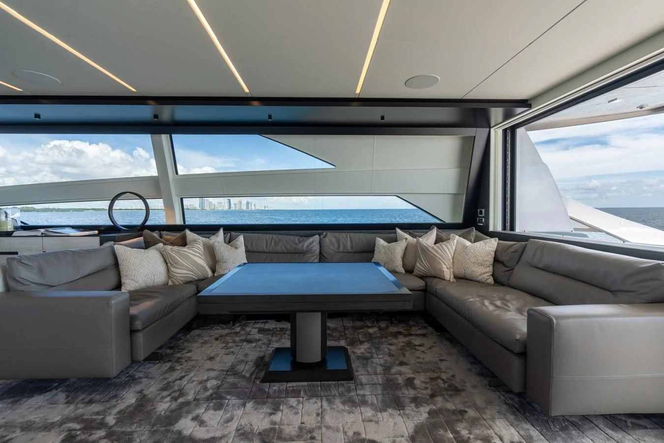 a couch and a table in a room aboard VINTAGE Yacht for Sale