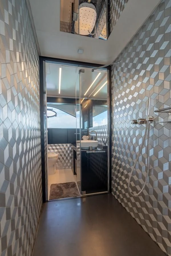 a bathroom with a glass shower aboard VINTAGE Yacht for Sale