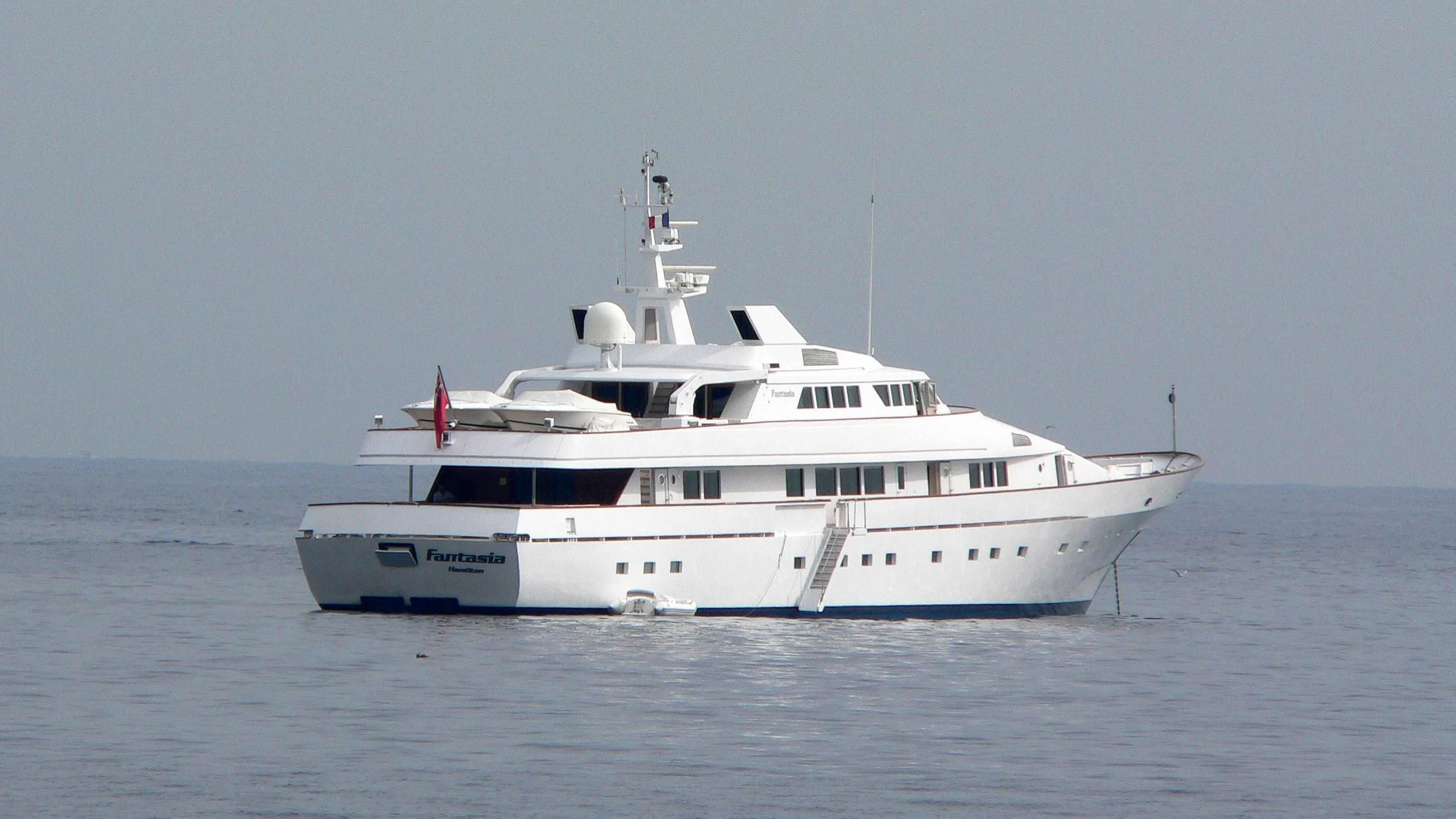 a white yacht in the water aboard FANTASIA Yacht for Sale