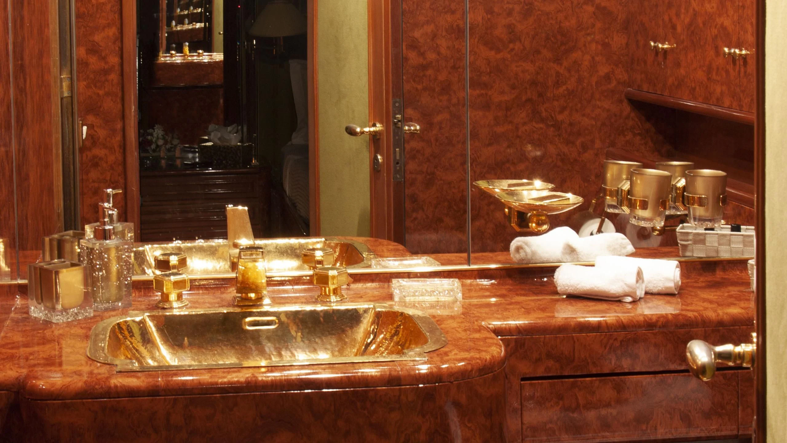 a bathroom counter with a sink and a large mirror aboard CHATO Yacht for Sale