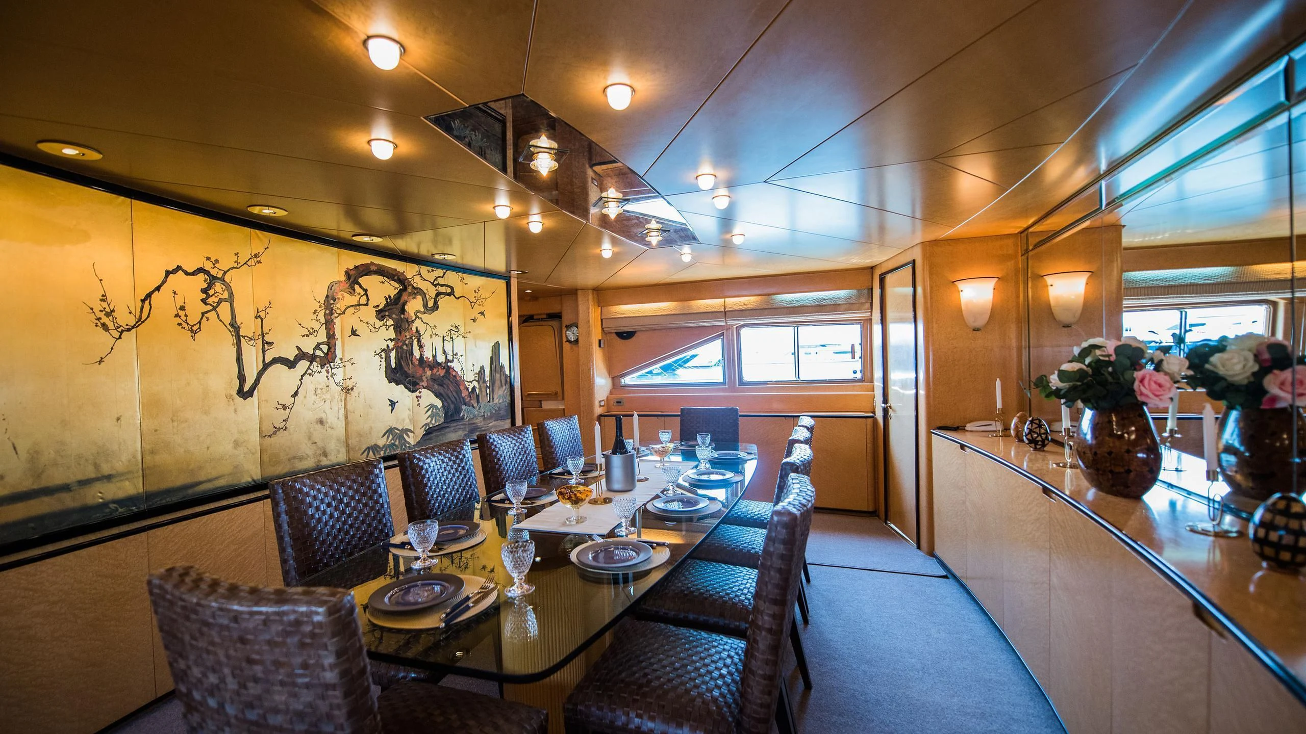 a dining room with a table and chairs aboard CHATO Yacht for Sale