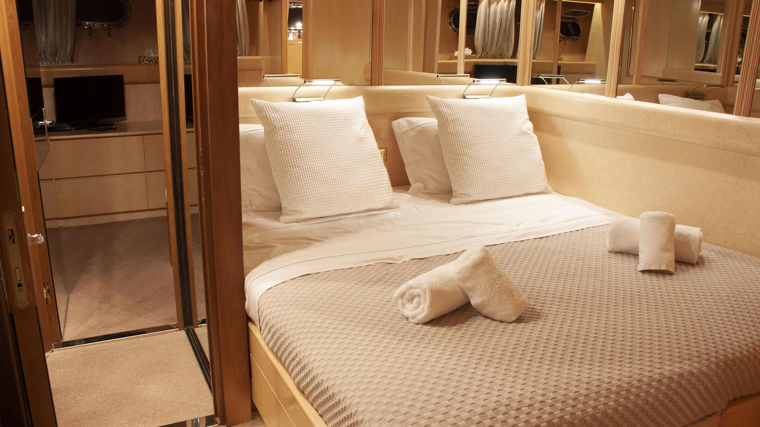 a bed with pillows aboard CHATO Yacht for Sale
