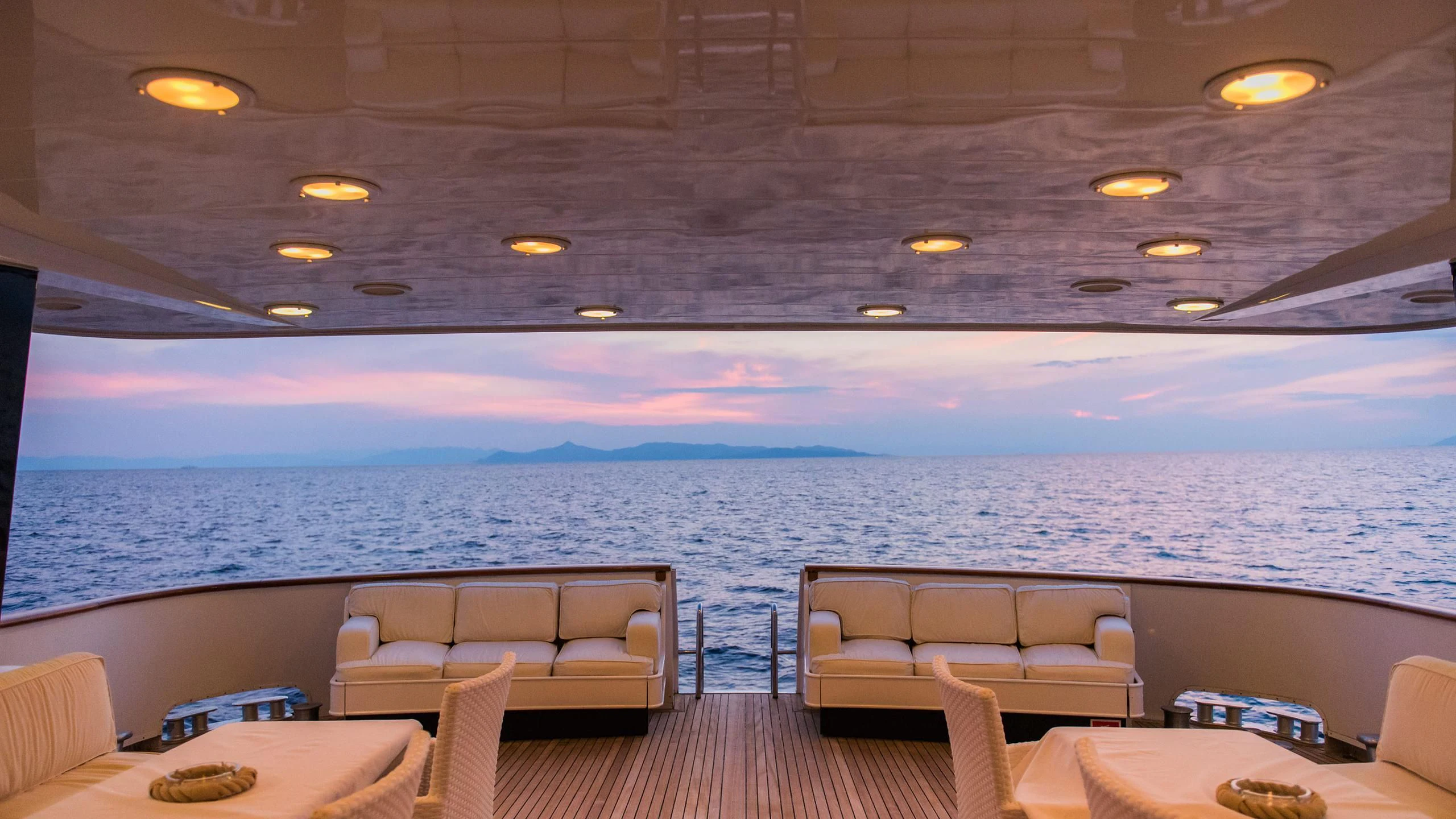 a room with a couch and a table and chairs aboard CHATO Yacht for Sale