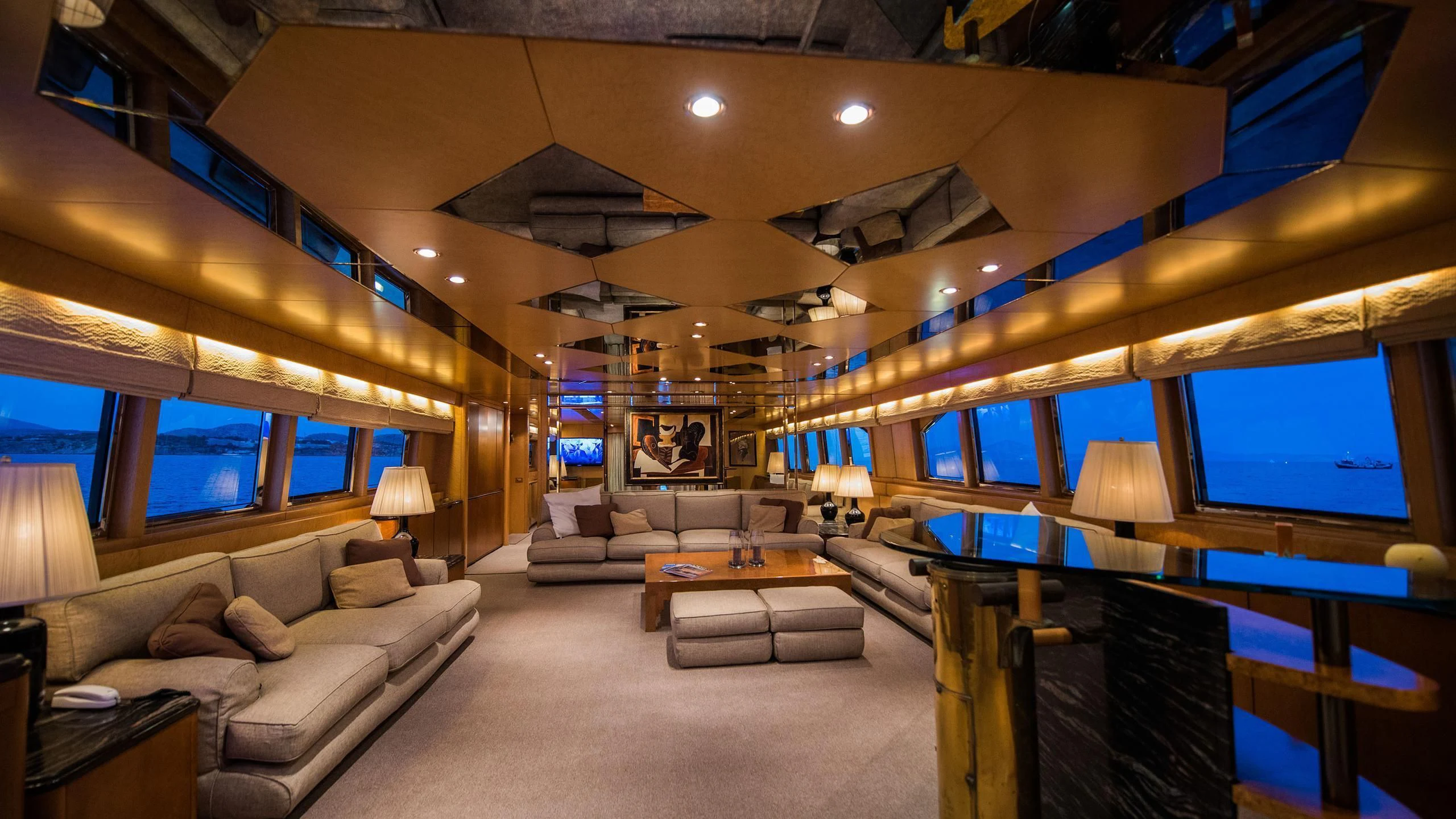 a living room with a large screen aboard CHATO Yacht for Sale