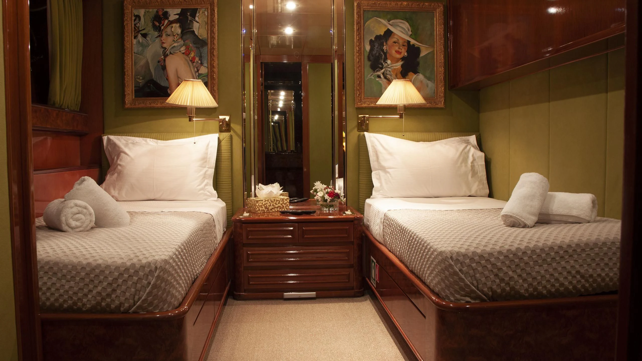 a couple of beds in a hotel room aboard CHATO Yacht for Sale
