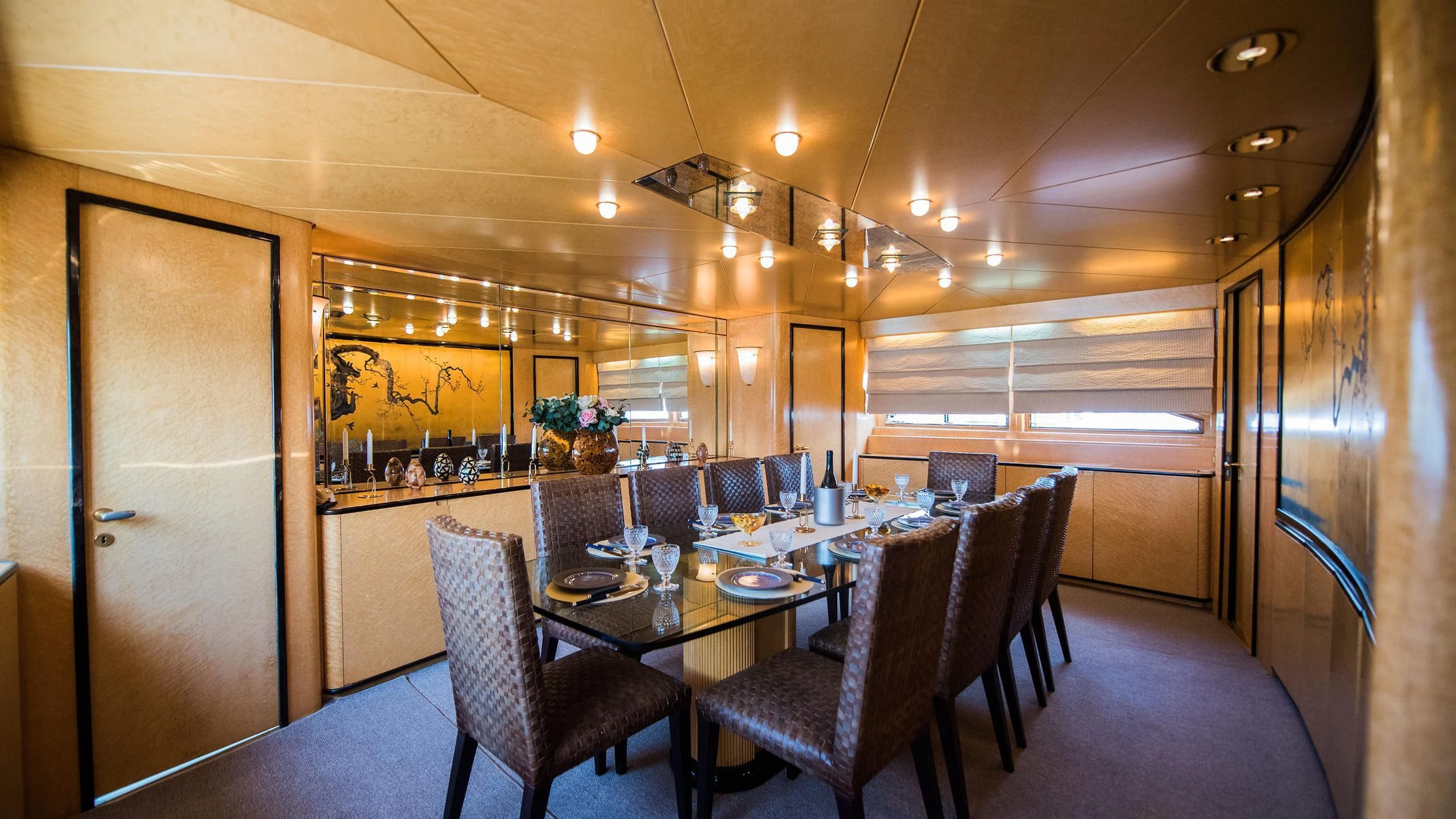 a dining room with a table and chairs aboard CHATO Yacht for Sale