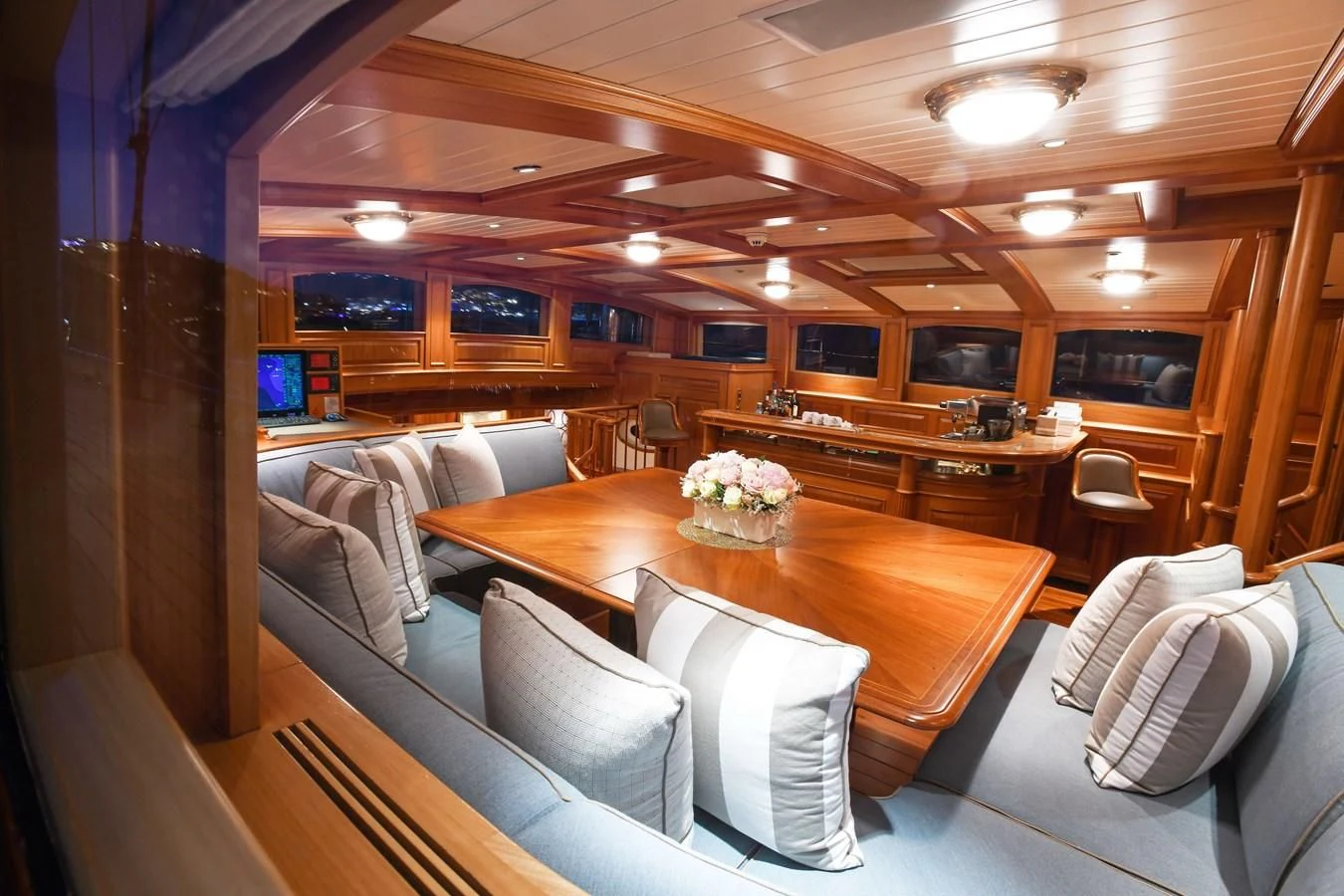 a living room with a table and chairs aboard HERMETICA Yacht for Sale