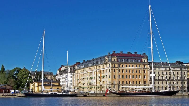 a large sailboat in front of a large building aboard HERMETICA Yacht for Sale