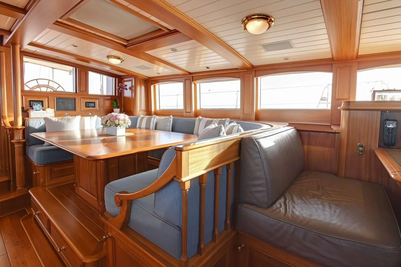 a living room with a couch and a table aboard HERMETICA Yacht for Sale