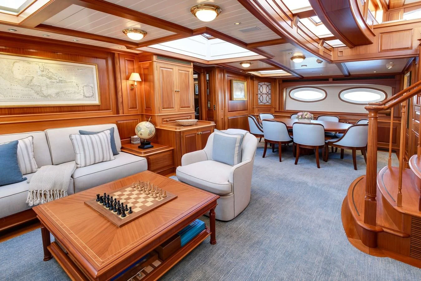 a large living room with a large table and chairs aboard HERMETICA Yacht for Sale