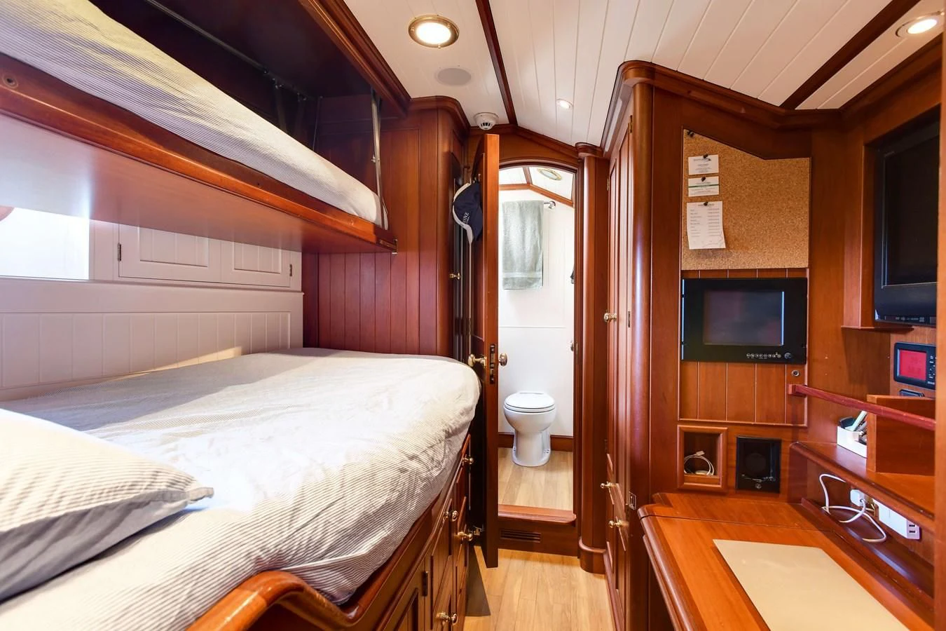 a bedroom with a bed and a television aboard HERMETICA Yacht for Sale