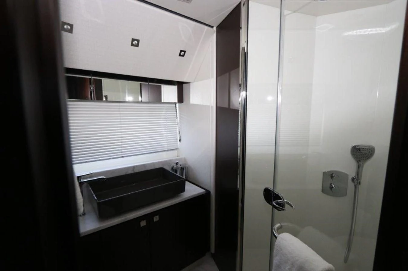 a bathroom with a shower and sink aboard HIDE OUT Yacht for Sale