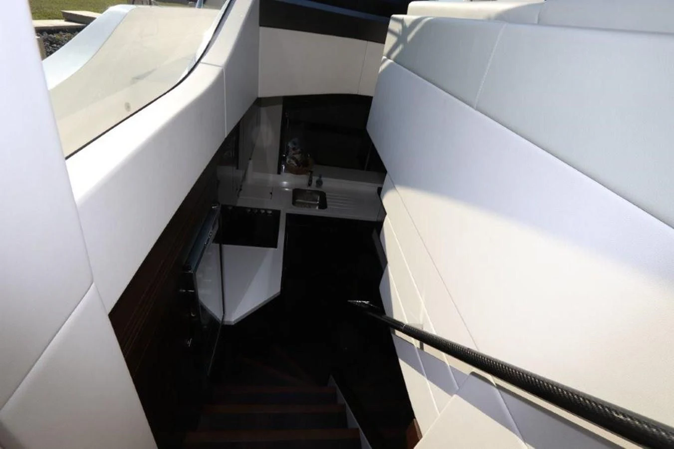 a white room with a black staircase aboard HIDE OUT Yacht for Sale