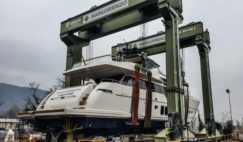 a large white boat on a lift aboard CHONY Yacht for Sale