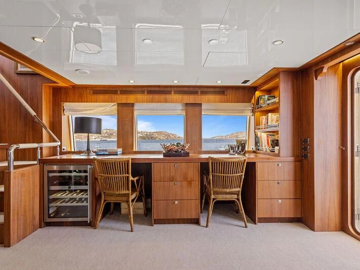 a room with a desk and chairs aboard O Yacht for Sale