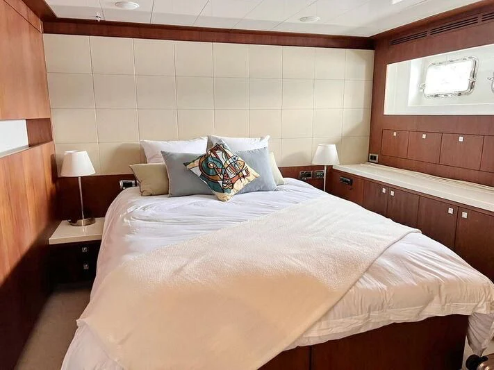 a bed with a pillow on it aboard O Yacht for Sale