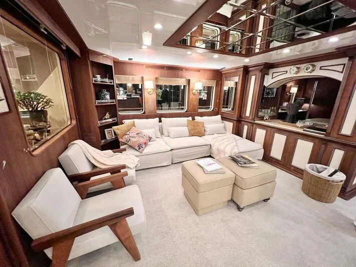 a living room with a fireplace aboard O Yacht for Sale