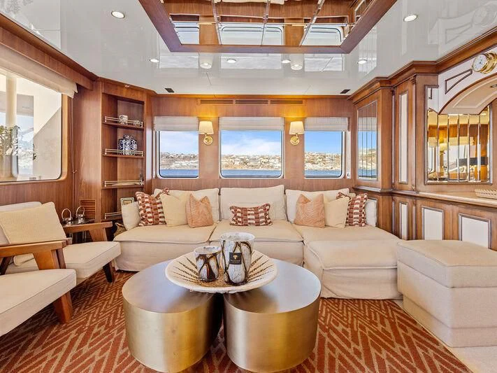 a living room with a large sofa aboard O Yacht for Sale