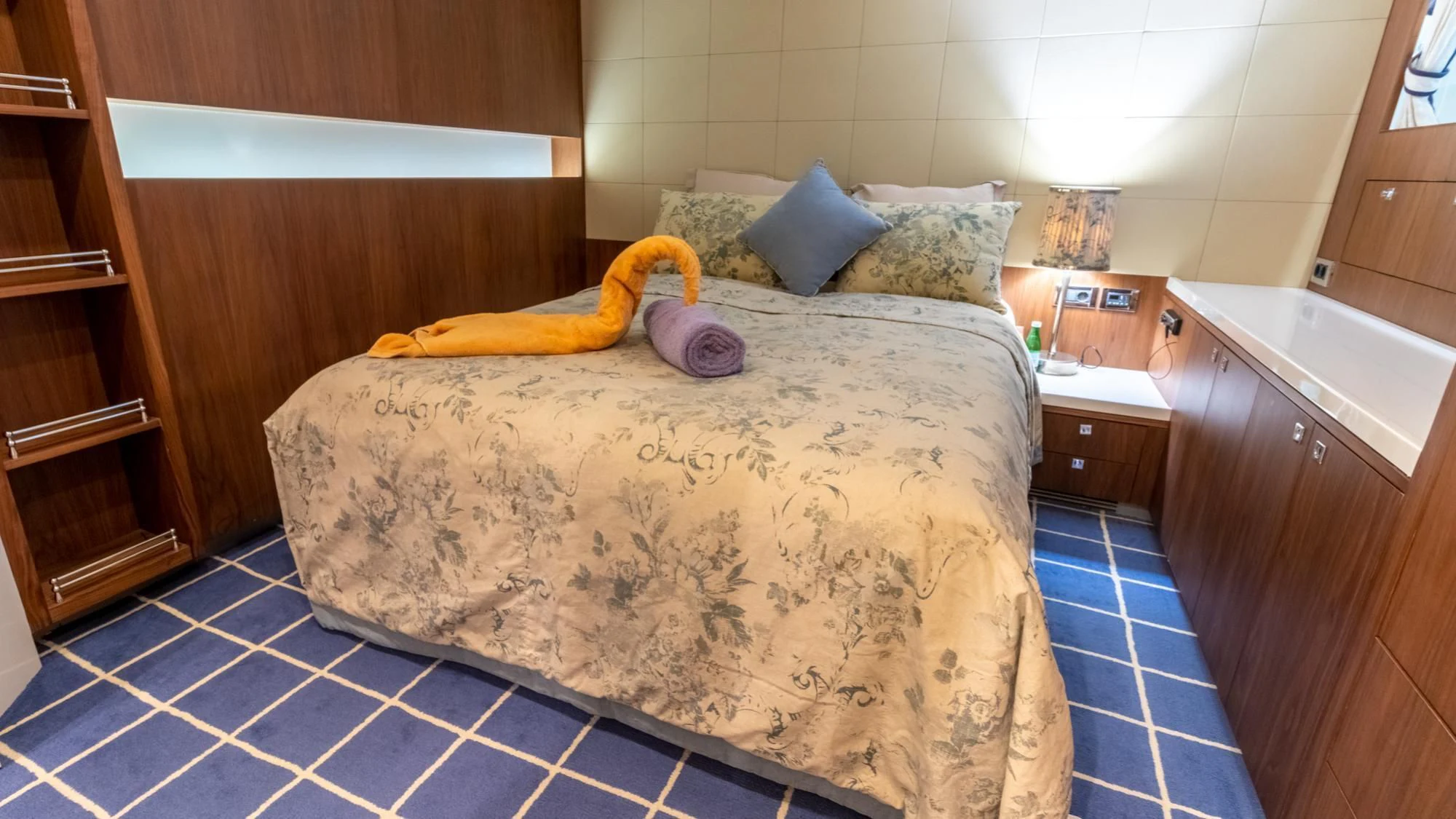 a bed with a blue and white tile floor aboard O Yacht for Sale