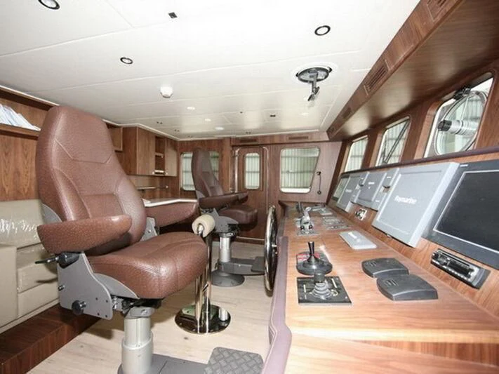 a room with a chair and a desk aboard O Yacht for Sale