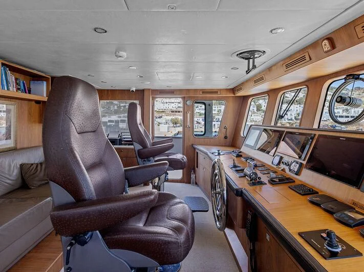 a living room with a leather chair aboard O Yacht for Sale