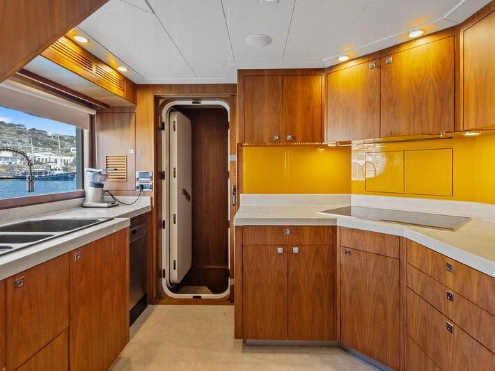 a kitchen with wooden cabinets aboard O Yacht for Sale