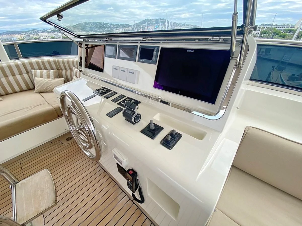 a room with a large tv and a couch aboard O Yacht for Sale