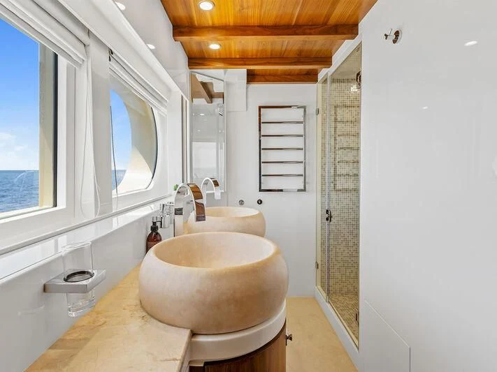 a bathroom with a sink and a mirror aboard O Yacht for Sale