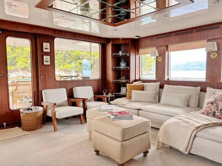 a living room with a couch and a table aboard O Yacht for Sale