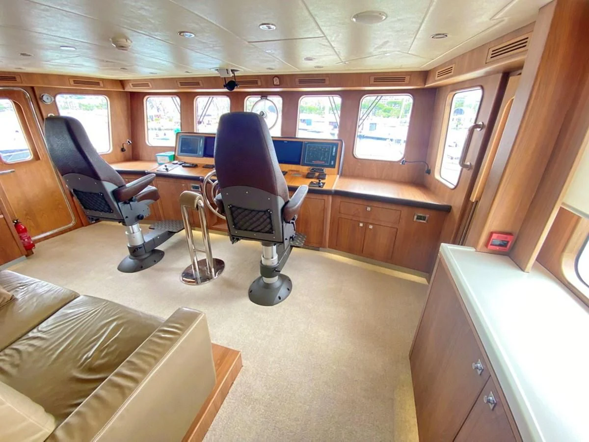 a room with a desk and chairs aboard O Yacht for Sale