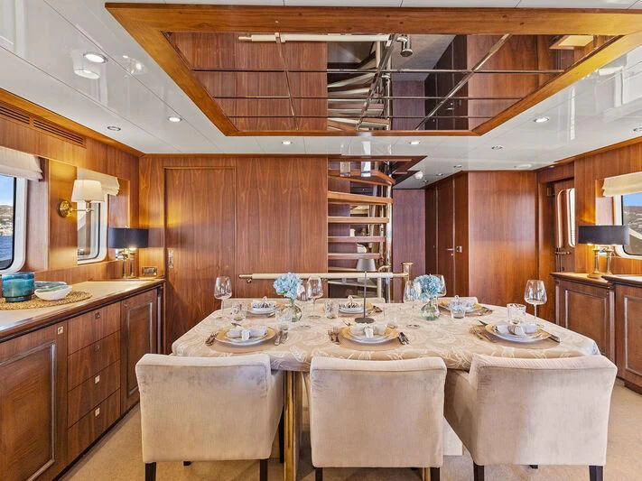a kitchen with a table and chairs aboard O Yacht for Sale