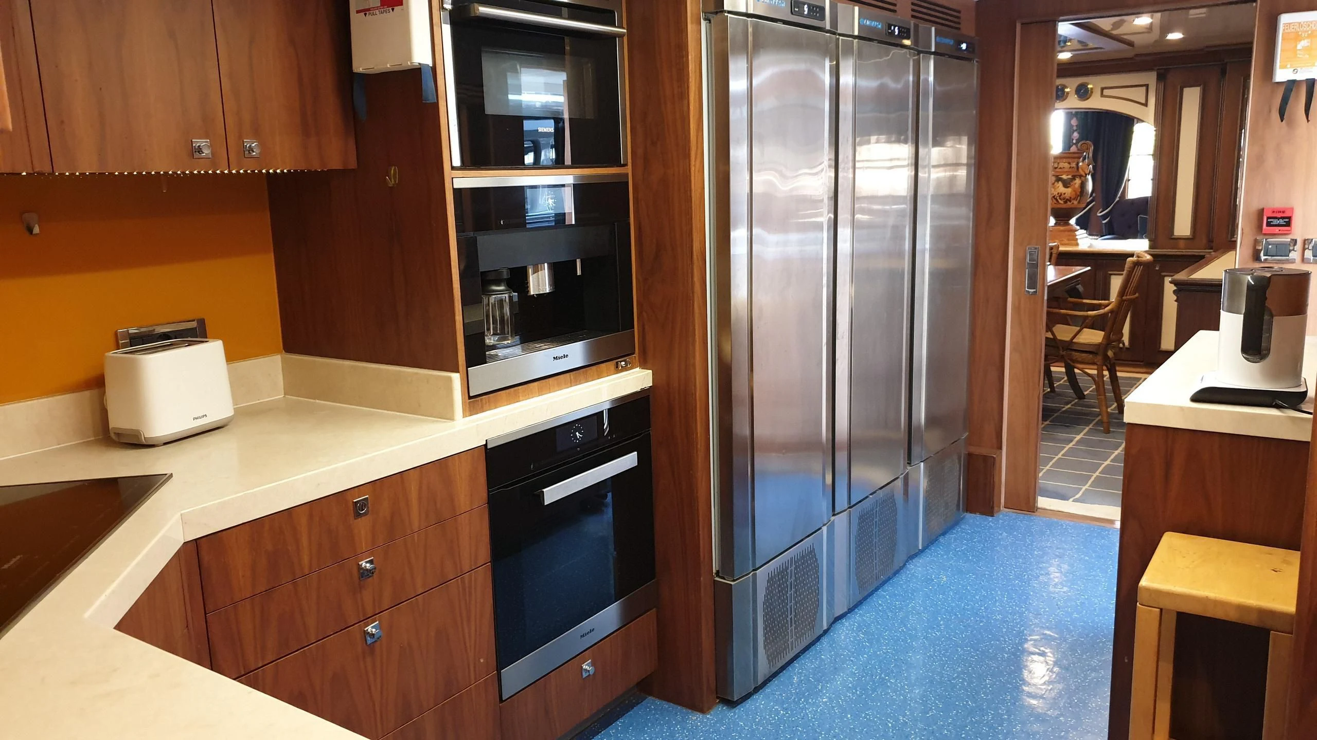 a large stainless steel refrigerator in a kitchen aboard O Yacht for Sale
