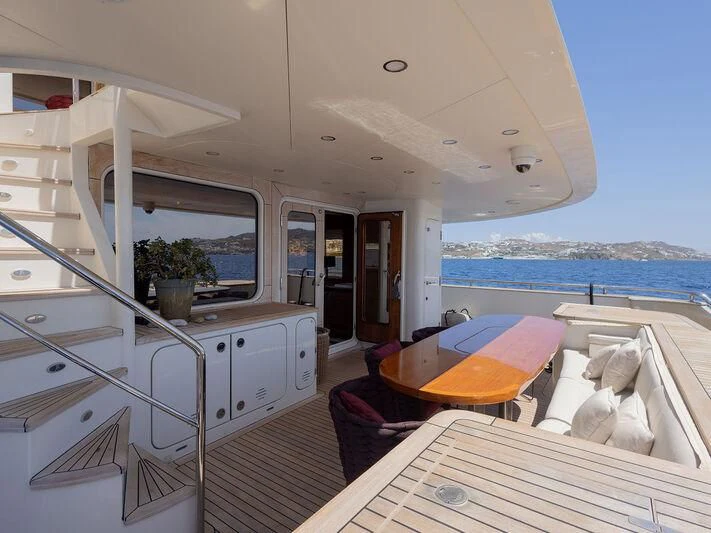 a boat with a table and chairs aboard O Yacht for Sale