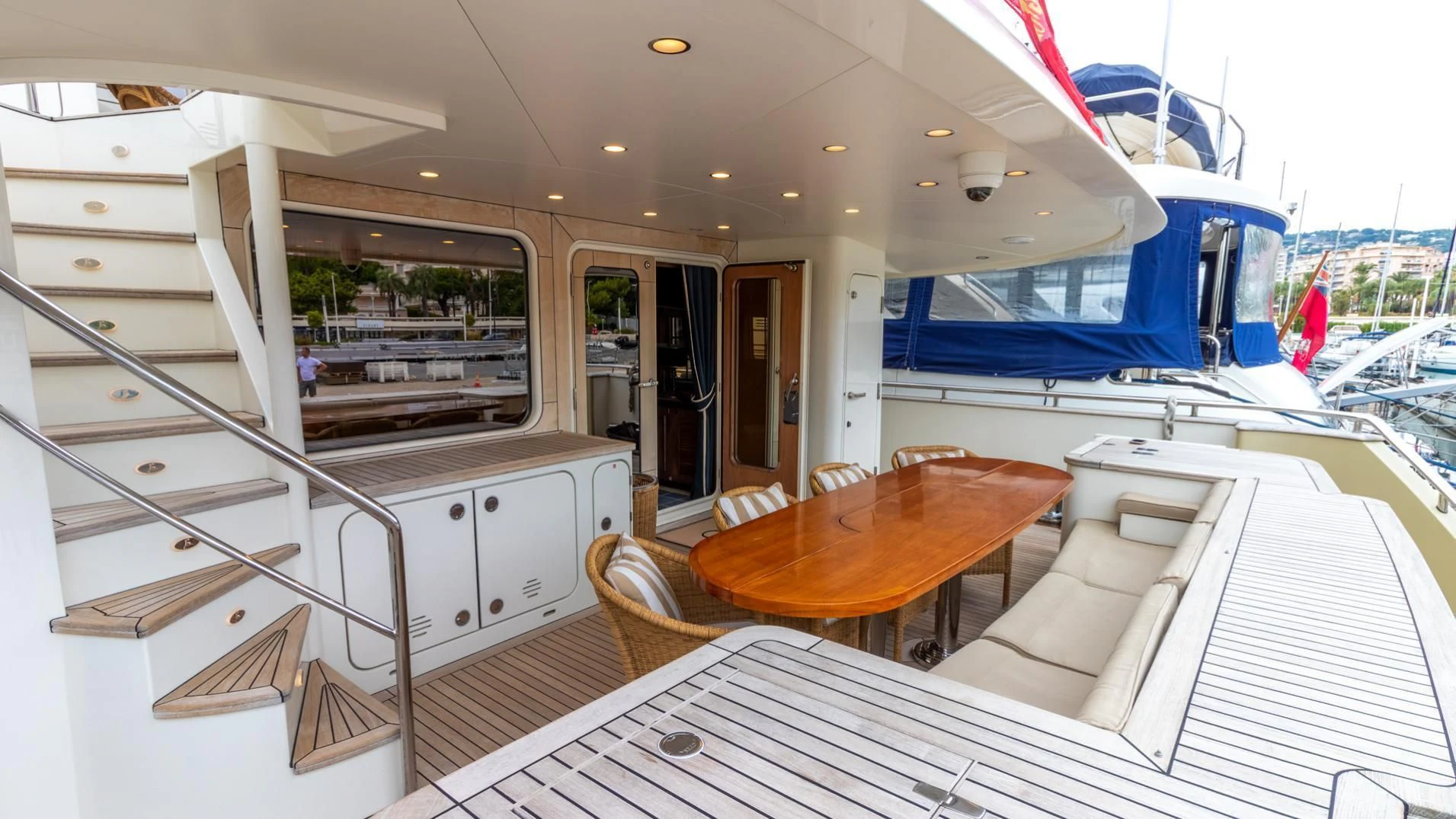 a boat with a table and chairs aboard O Yacht for Sale