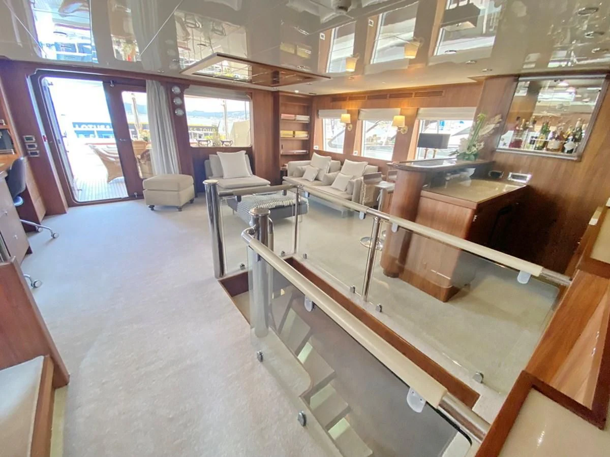 a room with a couch and a table aboard O Yacht for Sale