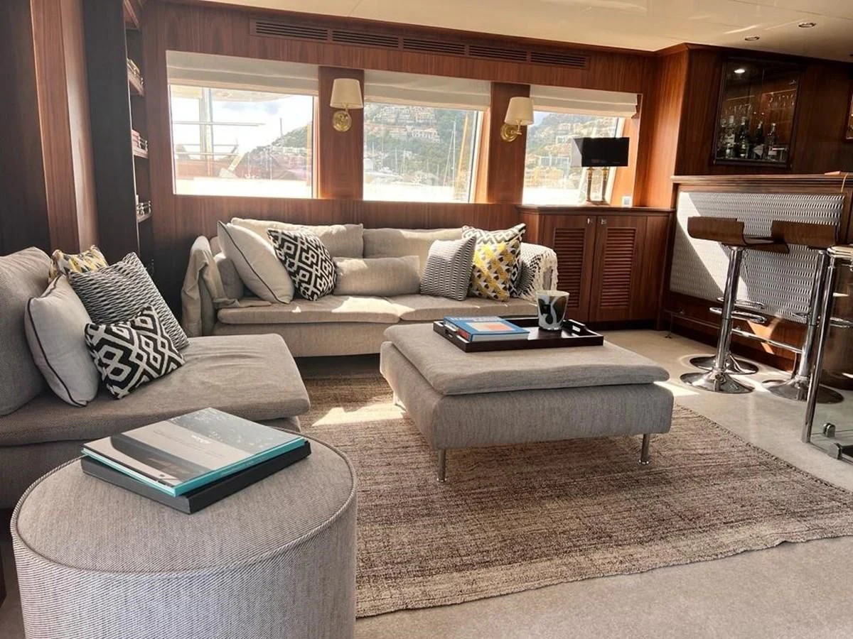 a living room with a couch and a coffee table aboard O Yacht for Sale
