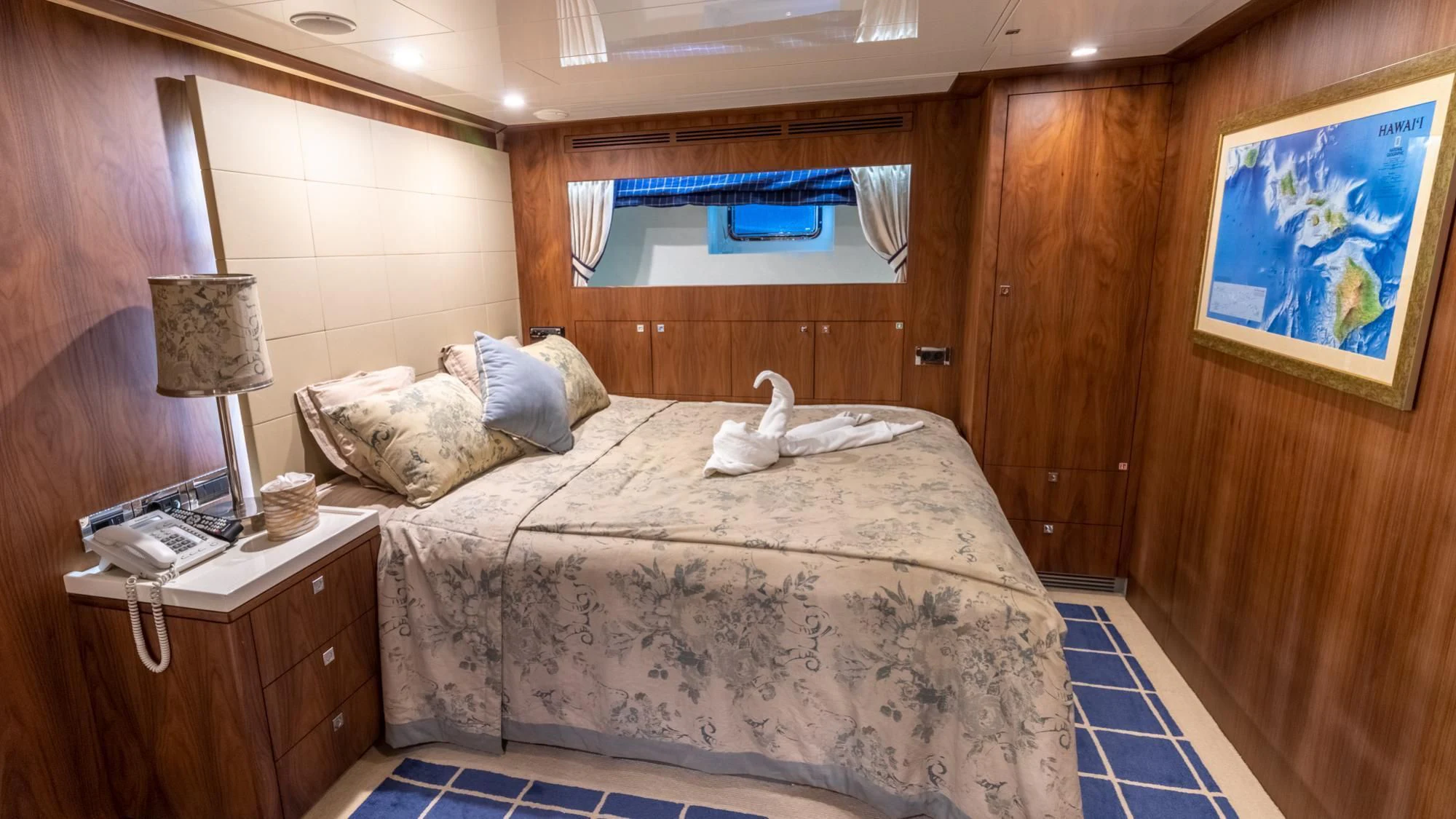 a bed with a white blanket aboard O Yacht for Sale
