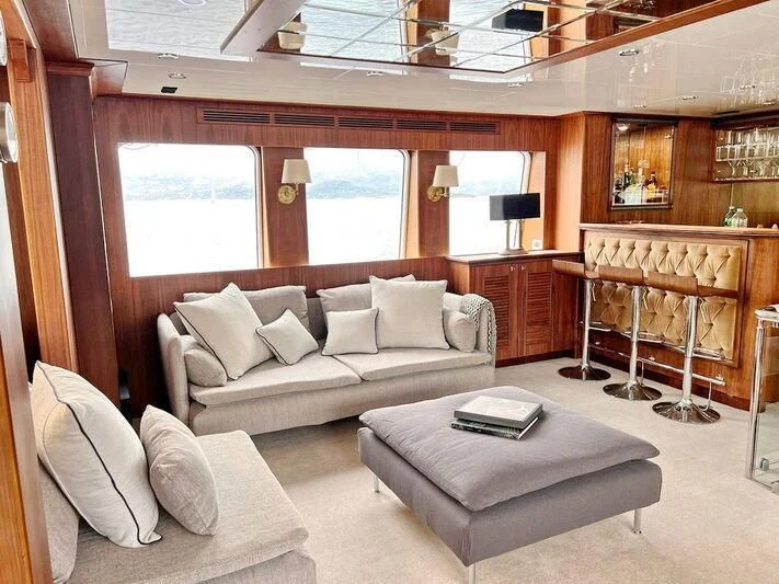 a living room with a couch and a fireplace aboard O Yacht for Sale