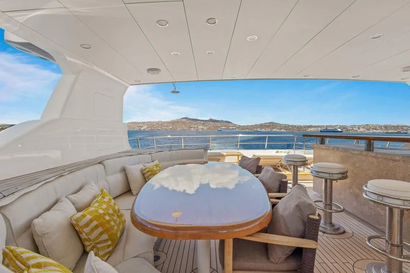 a room with a table and chairs aboard O Yacht for Sale