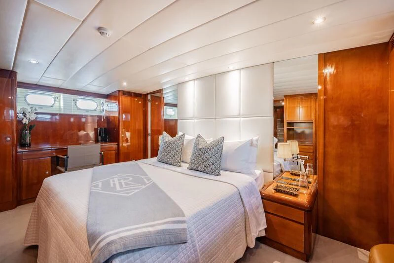 a bedroom with a bed and a desk aboard O Yacht for Sale